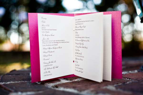White wedding program with dark pink cover standing open - photo by North Carolina based wedding photographer Jeremie Barlow